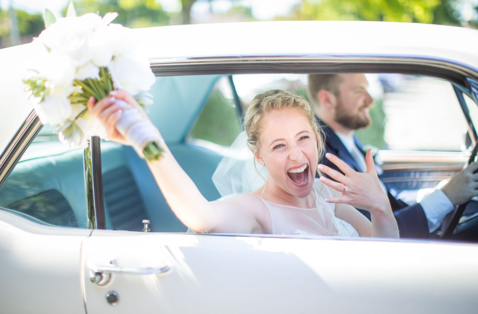 bride in vintage car excited about marriage